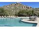 Inviting community pool with ample lounge chairs and mountain views at 7473 E Soaring Eagle Way, Scottsdale, AZ 85266