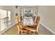 Bright dining room with long wood table and built-in shelving at 30346 W Columbus Ave, Buckeye, AZ 85396