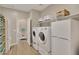 Bright laundry room with storage and a view to another room at 30346 W Columbus Ave, Buckeye, AZ 85396