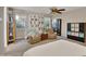 Main bedroom with built-in shelving and ceiling fan at 30346 W Columbus Ave, Buckeye, AZ 85396