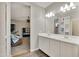 Double vanity bathroom with white cabinets and tile floor at 30346 W Columbus Ave, Buckeye, AZ 85396