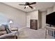 Cozy bedroom with ceiling fan, dresser, and TV setup at 30346 W Columbus Ave, Buckeye, AZ 85396