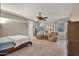 Main bedroom with built-in shelving and ceiling fan at 30346 W Columbus Ave, Buckeye, AZ 85396