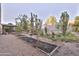 Landscaped backyard with garden beds and a gazebo at 30346 W Columbus Ave, Buckeye, AZ 85396