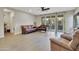 Bright living room with hardwood floors and sliding glass doors to backyard at 30346 W Columbus Ave, Buckeye, AZ 85396