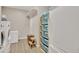 Laundry room with washer, dryer, and built-in shelving at 30346 W Columbus Ave, Buckeye, AZ 85396