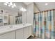 Double vanity bathroom with white cabinets and tile floor at 30346 W Columbus Ave, Buckeye, AZ 85396