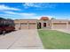 Three-car garage with landscaped yard and driveway at 10224 E Michigan Ave, Sun Lakes, AZ 85248
