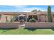 Private backyard with a patio, landscaping, and gated access at 10224 E Michigan Ave, Sun Lakes, AZ 85248