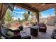 Spacious patio with seating area, fire pit, and built-in grill, overlooking a golf course at 10224 E Michigan Ave, Sun Lakes, AZ 85248