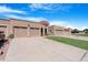 Three-car garage home with a front yard and driveway at 10224 E Michigan Ave, Sun Lakes, AZ 85248