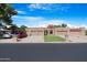 Three-car garage home with a front yard and driveway at 10224 E Michigan Ave, Sun Lakes, AZ 85248