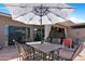 Outdoor patio with dining table and chairs, umbrella, and access to the house at 10224 E Michigan Ave, Sun Lakes, AZ 85248