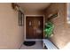 Inviting front entrance with double doors, a small bench, and potted plants at 10224 E Michigan Ave, Sun Lakes, AZ 85248
