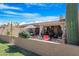 Relaxing backyard oasis featuring a patio, seating area, and lush landscaping at 10224 E Michigan Ave, Sun Lakes, AZ 85248