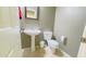 Clean bathroom with pedestal sink, toilet, and tiled floor at 15409 W Corrine Dr, Surprise, AZ 85379