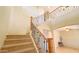 Elegant staircase with wrought iron railing and wooden handrail at 15409 W Corrine Dr, Surprise, AZ 85379