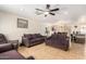 Living room with tiled floors, couches, and a ceiling fan at 3127 N 79Th Dr, Phoenix, AZ 85033