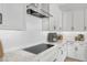 Modern kitchen features granite countertops, white cabinets, and a cooktop at 22427 E Oriole Way, Queen Creek, AZ 85142