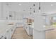 Open concept kitchen with an island, white cabinets, and pendant lighting at 22427 E Oriole Way, Queen Creek, AZ 85142