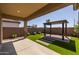 Covered patio with artificial turf and pergola at 22427 E Oriole Way, Queen Creek, AZ 85142