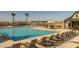 Community pool with lounge chairs and shaded seating areas at 22427 E Oriole Way, Queen Creek, AZ 85142