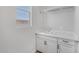 Laundry room with white cabinets, a sink, and a window at 22427 E Oriole Way, Queen Creek, AZ 85142