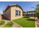 Home's exterior and backyard with pergola and artificial grass at 22427 E Oriole Way, Queen Creek, AZ 85142