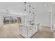 Modern kitchen island with breakfast bar and view of backyard at 22427 E Oriole Way, Queen Creek, AZ 85142