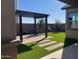 Landscaped backyard with pergola and artificial turf at 22427 E Oriole Way, Queen Creek, AZ 85142