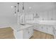 Modern kitchen with white cabinetry and large island at 22427 E Oriole Way, Queen Creek, AZ 85142