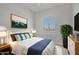 Bedroom with a queen-size bed, window, and modern decor at 22427 E Oriole Way, Queen Creek, AZ 85142