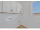 Laundry room with white cabinets and a window at 22427 E Oriole Way, Queen Creek, AZ 85142