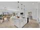 Open kitchen with large island, breakfast bar and backyard view at 22427 E Oriole Way, Queen Creek, AZ 85142