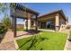 Backyard with pergola, grass, and sliding glass door access at 22427 E Oriole Way, Queen Creek, AZ 85142