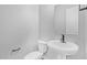 Small bathroom with pedestal sink, toilet, and mirror at 22427 E Oriole Way, Queen Creek, AZ 85142
