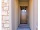 Inviting entryway with a modern, wood door at 22427 E Oriole Way, Queen Creek, AZ 85142