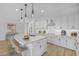 Stylish kitchen with white cabinets, quartz countertops and breakfast bar at 22427 E Oriole Way, Queen Creek, AZ 85142