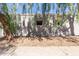 Exterior view of a condo with storage and a tree at 4820 N 89Th Ave # 100, Phoenix, AZ 85037