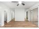 Bedroom with wood-look floors, mirrored walls, and patio access at 4820 N 89Th Ave # 100, Phoenix, AZ 85037