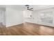 Living room featuring wood-look floors and access to kitchen at 4820 N 89Th Ave # 100, Phoenix, AZ 85037