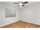 Spacious bedroom with wood-look flooring and ceiling fan at 4820 N 89Th Ave # 100, Phoenix, AZ 85037