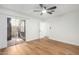 Bedroom with wood-look floors and patio access at 4820 N 89Th Ave # 100, Phoenix, AZ 85037