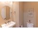 Charming half bathroom with a pedestal sink and decorative wall art at 16917 W Sheridan St, Goodyear, AZ 85395
