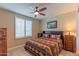 Spacious bedroom with a king-size bed, tiled floors and window shutters at 16917 W Sheridan St, Goodyear, AZ 85395