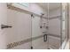 Modern shower with glass enclosure, tiled walls, and built-in seating at 16917 W Sheridan St, Goodyear, AZ 85395