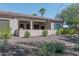 Covered patio with seating area, desert landscaping, and a gravel yard at 16917 W Sheridan St, Goodyear, AZ 85395