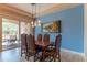 Elegant dining room with a rustic wood table and leather chairs at 16917 W Sheridan St, Goodyear, AZ 85395