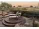 Peaceful backyard with a water feature, lounge chairs, and golf course views at 22455 N 55Th St, Phoenix, AZ 85054