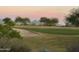 View of a green with sand traps and distant mountains at 22455 N 55Th St, Phoenix, AZ 85054